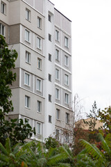 Residential high-rise buildings in a suburban area with greenery and urban surroundings during an overcast day