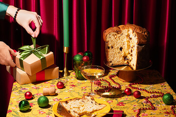 Woman Placing Christmas Gifts on Festive Table with Panettone