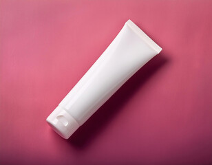 Blank white cosmetic tube on pink background. Beauty product mockup
