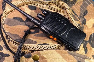 Radio station on camouflage background. Walkie-talkie with channel switches, volume control and...