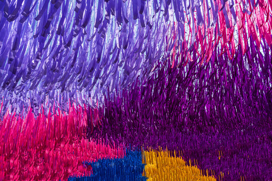 Vibrant Layers of Purple, Pink, and Yellow Ribbons in Festival Decor