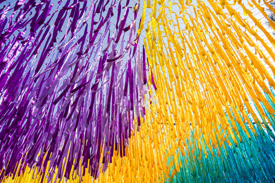 Colorful Ribbons Hanging Overhead in Outdoor Festival Decoration