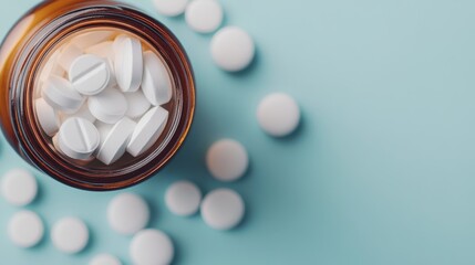 A brown amber pill bottle is tipped over on a flat blue surface, spilling white round tablets, depicting medication, health, and pharmacy themes.