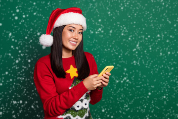 Photo of funny cute lady wear red ugly print xmas sweater cap typing instagram twitter telegram...