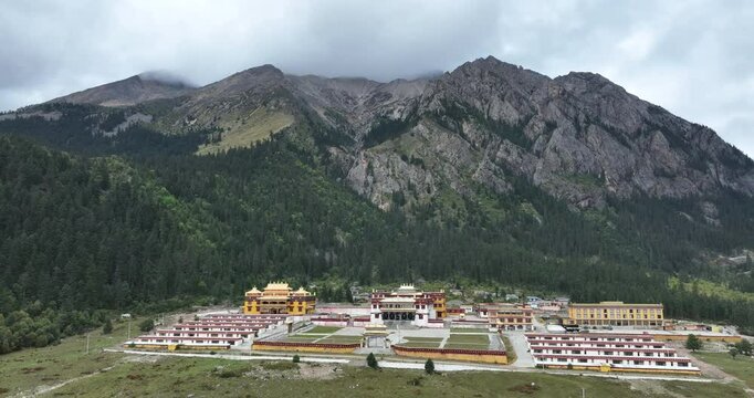 Aerial footage of Lenggu Monastery in beautiful high altitude mountains landscape
