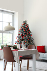 Festive table setting in living room with Christmas tree