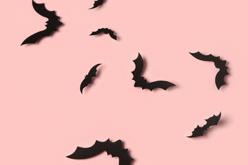 Paper bats for Halloween party on pink background