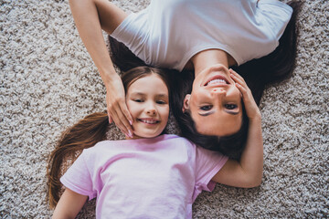 Top view photo of adorable cute mommy and her daughter enjoying carefree time together indoors