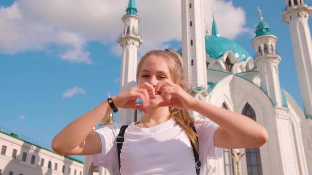 Beautiful tourist girl at kul sharif mosque on a sunny summer day in Kazan, Tatarstan.
