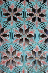 Colorful geometric pattern decorating the wall of a building, showing vibrant colors and intricate details