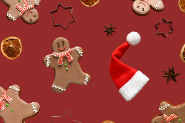 Sweet gingerbread cookies with Christmas decor on red background.