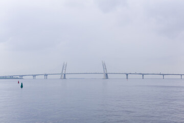 distant bridge over foggy bay on rainy day