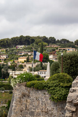 A French flag flies over the high fortified walls of the medievel village of Saint Paul de Vence in the south of France
