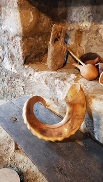 Ram's horn in the interior of a village house, a ram's horn on a bench near a stone wall