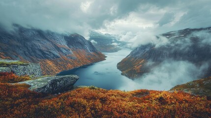 Mountain Lake Surrounded by Misty Peaks and Autumn Foliage