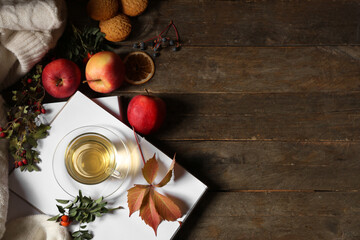 Autumn composition with cup of green tea, notebooks and apples on wooden background