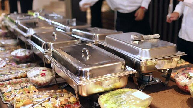 A sumptuous buffet spread features a variety of dishes laid out in chafing dishes and platter settings, inviting guests to enjoy a delightful meal together in a festive atmosphere.