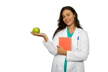 Portrait of a young female doctor in a lab coat holding a green apple