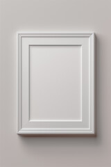 Minimalist white picture frame mounted on a plain wall, casting soft shadows.
