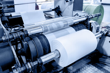 Polyethylene plastic bag production, sunlight. Closeup roller of industry machine for packaging
