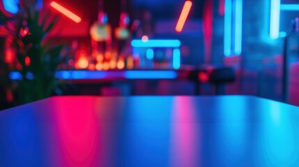 Empty table in a nightclub with neon lights and blurry background.