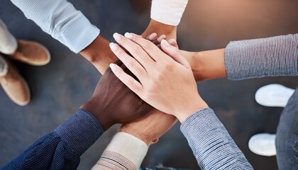 A group of people with their hands in the middle and stacked on top of each other's hands; a team huddle with all hands on deck; teamwork makes the dream work; communication photography