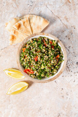 Tabbouleh Salad with Tomatoes, Pita Bread, and Lemon Slices