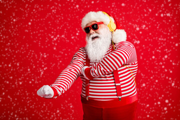 Portrait of his he handsome bearded fat overweight cheerful cheery dreamy Santa fan meloman listening single sound dancing having fun isolated bright vivid shine vibrant red color background