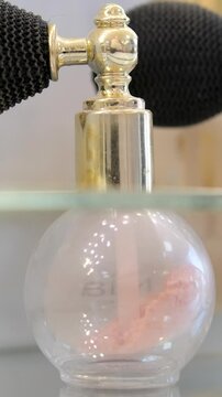 Luxury golden perfume bottle and shining light flares on pink background, glamorous fragrance scent as perfumery product for cosmetic and beauty brand. perfume bottles