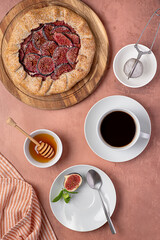 Food photography of galette with figs and ricotta, sweet pie, shortcrust pastry, dessert, whole wheat flour, icing sugar, coffee, honey