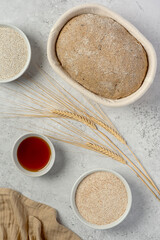 Food photography of whole grain rye and wheat sourdough bread, fermented raw dough, caraway seed, malt, grain, nutritional