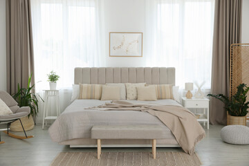 Big comfortable bed in room. Interior design