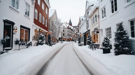Fototapeta premium Snow blankets the charming streets of Quebec City's old town, where festive decorations and vibrant buildings create a picturesque winter atmosphere at Christmas
