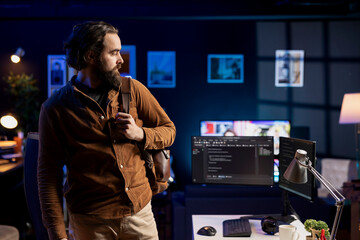 Man leaving home office after finishing software quality assurance and reading source code....