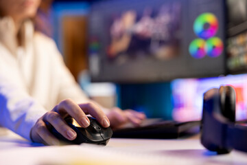 Professional video editor editing color grading and lighting in creative office, analyzing film...