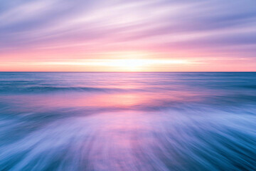 Obraz premium pastel sunset colors on ocean, horizon line in the middle of the frame.