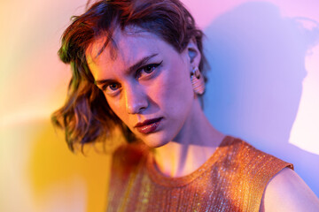 Woman under neon lights with intense gaze