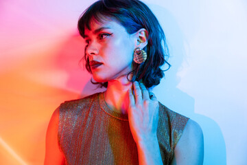 Fashionable woman with colorful, dramatic lighting