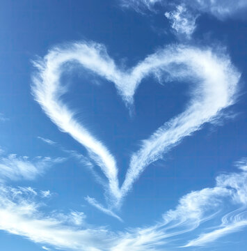 heart shaped cloud skywriting in the blue sky 