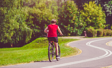 Fototapeta premium Cyclist ride on the bike path in the city Park 