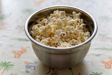 Natural popcorn in a stainless steel bowl.
