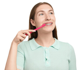 Girl with braces cleaning teeth on white background