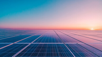 Solar panels at sunset, reflecting a beautiful pink and blue sky.