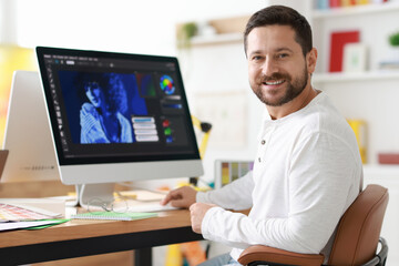 Designer working with computer at table in office