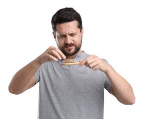 Sad man taking his lost hair from brush on white background. Alopecia problem