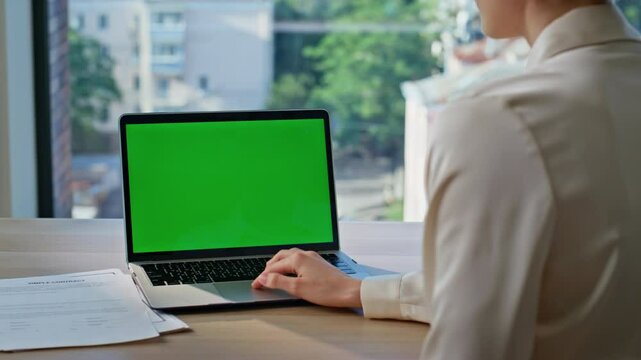Freelancer touching green screen laptop touchpad at modern office closeup. 