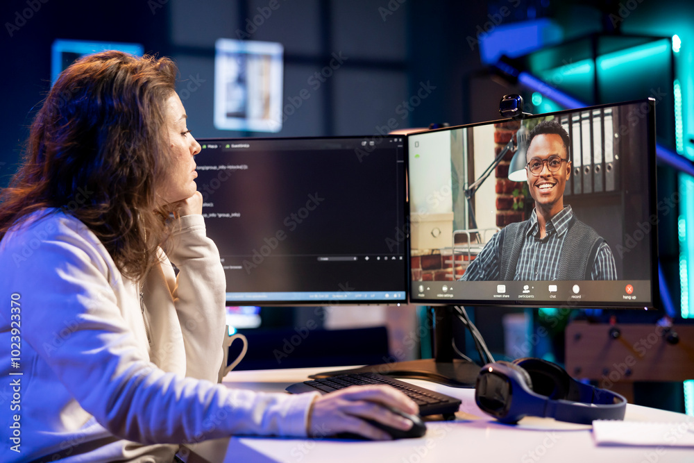 Poster admin doing company software debugging, talking with management in videocall about errors found in c