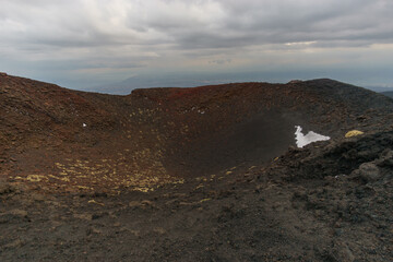 Volcanic landscape of Mount Etna near the Silvester craters on a cloudy winter day, Catania, Sicily, Italy