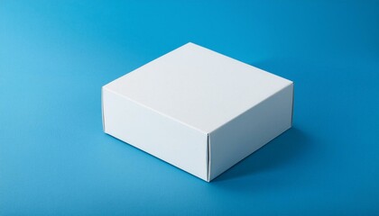 Naklejka premium Realistic blank white product package box mockup, blue background. Macro shot (