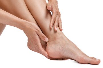 Woman touching her smooth feet on white background, closeup